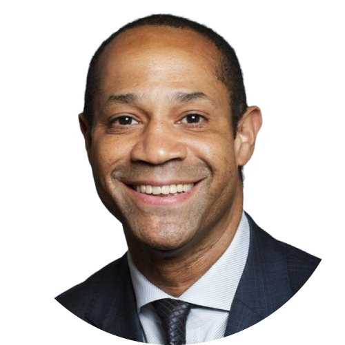 A man in suit and tie smiling for the camera.