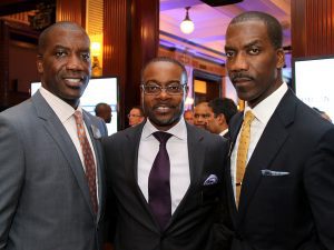Three men in suits and ties posing for a picture.