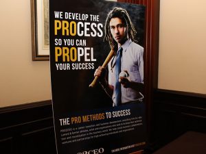 A poster of a man holding an axe and wearing a tie.